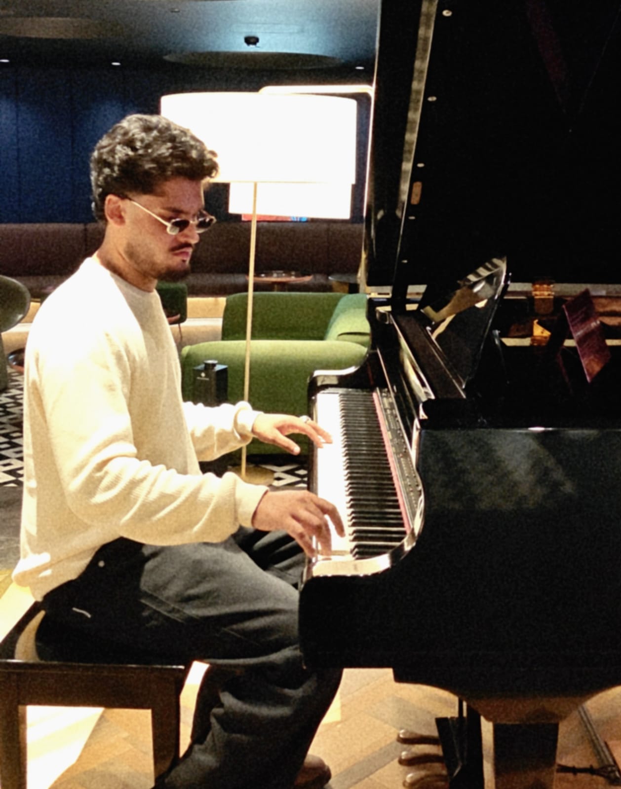 Aditya Sreekumar sitting at a piano